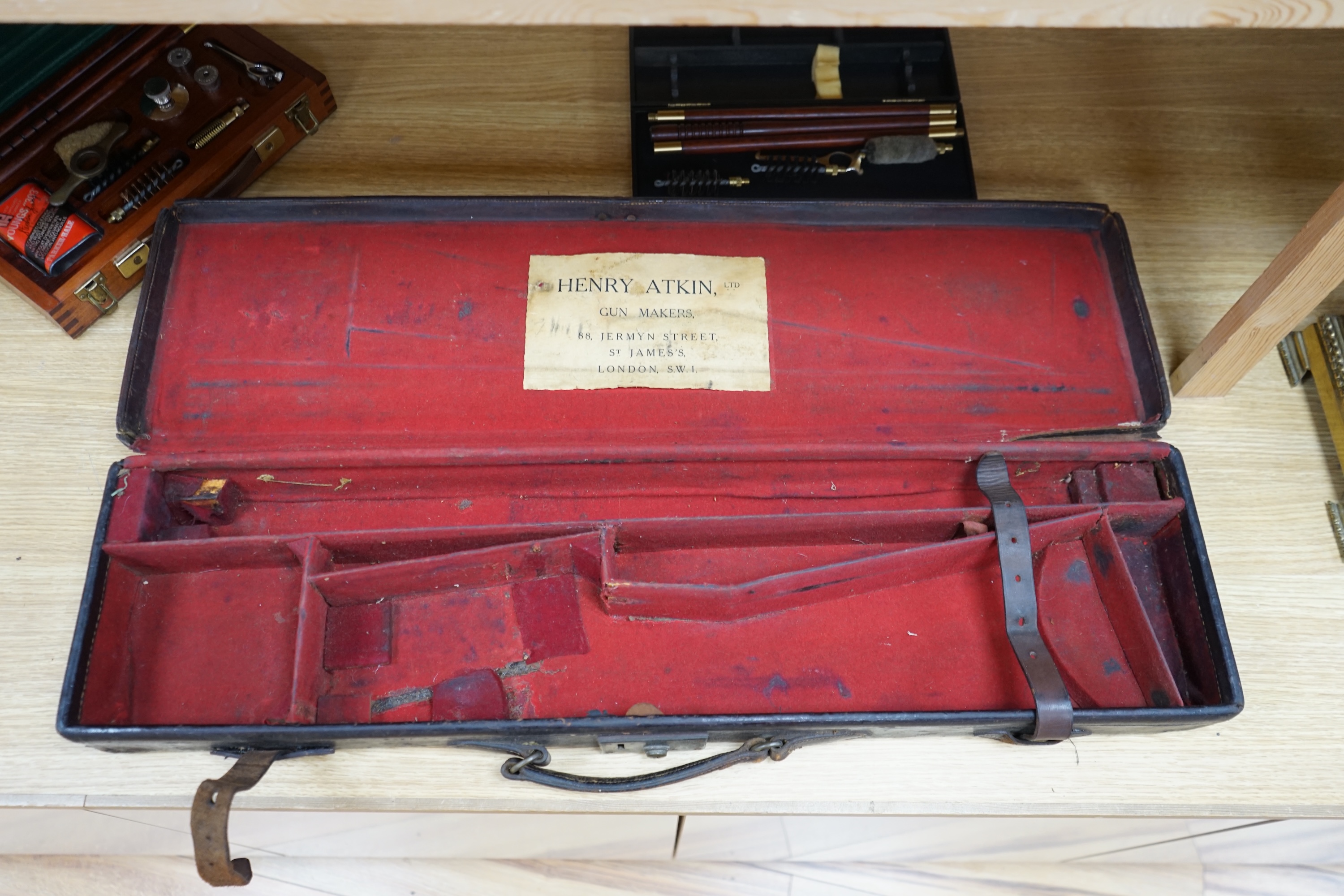 Two cases of gun cleaning equipment and a 19th century leather gun case, 83cm long. Condition - fair to good